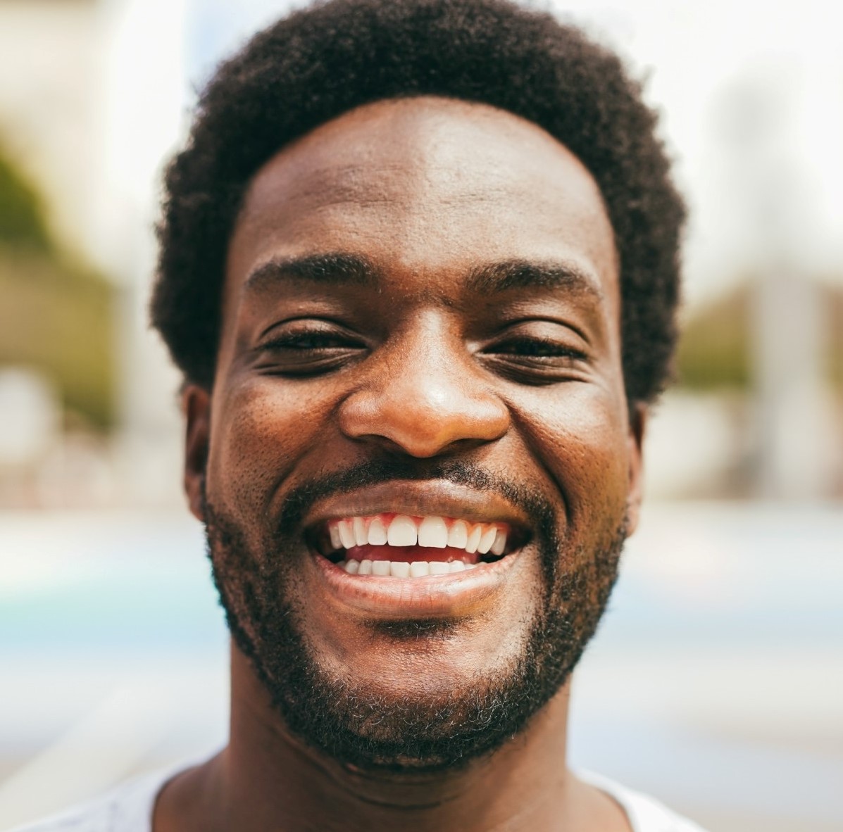 happy african man smiling at camera inside ba 1.jpg